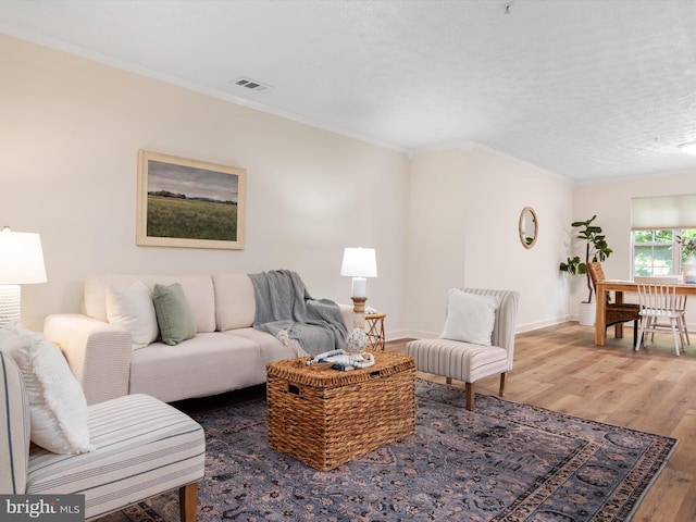 621 Admiral Dr Unit 207, Annapolis, MD 21401 - living room with wood finished floors, ornamental molding, baseboards, and a textured ceiling
