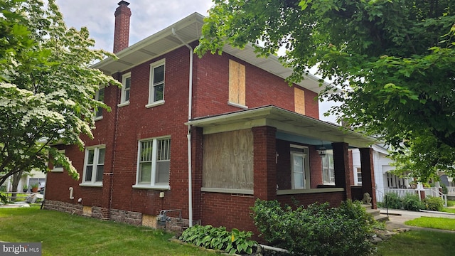 4759 Carlisle Rd, Dover, PA 17315 - view of home's exterior featuring a chimney, brick siding, and a yard
