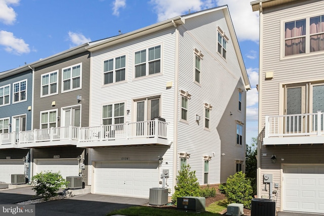 13126 Hawkeye Aly, Clarksburg, MD 20871 - rear view of property with central AC unit, a garage, and a balcony