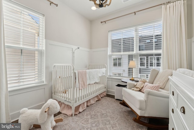 13126 Hawkeye Aly, Clarksburg, MD 20871 - bedroom with multiple windows, a wainscoted wall, a crib, and a decorative wall