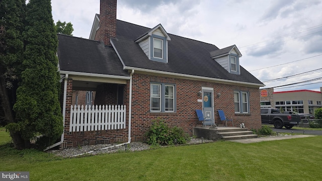 2103 W Trindle Rd, Carlisle, PA 17013 - cape cod home featuring brick siding, a front yard, and a chimney