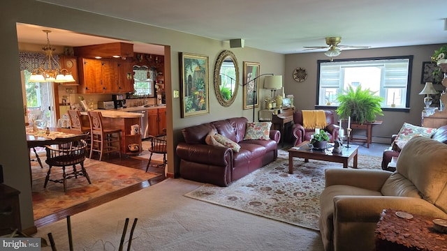 1030 Walt Rd, Pennsburg, PA 18073 - living area featuring a chandelier, carpet flooring, a ceiling fan, and a baseboard radiator
