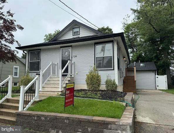 124 Washington Ave, Mount Ephraim, NJ 08059 - view of front facade featuring driveway, a garage, and a gate