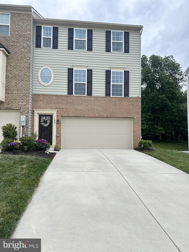 182 Mohegan Dr, Havre De Grace, MD 21078 - view of front facade featuring a garage, brick siding, concrete driveway, and a front lawn