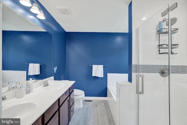 182 Mohegan Dr, Havre De Grace, MD 21078 - bathroom featuring a bath, double vanity, wood finished floors, toilet, and a shower stall
