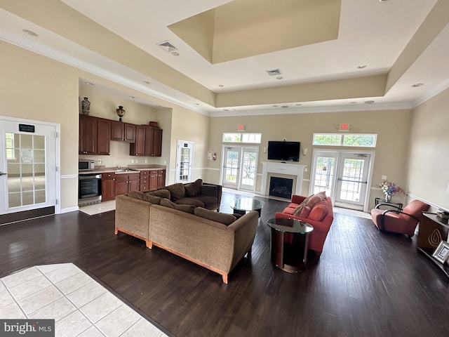 182 Mohegan Dr, Havre De Grace, MD 21078 - living room with a tray ceiling, dark wood-style flooring, a fireplace, crown molding, and recessed lighting