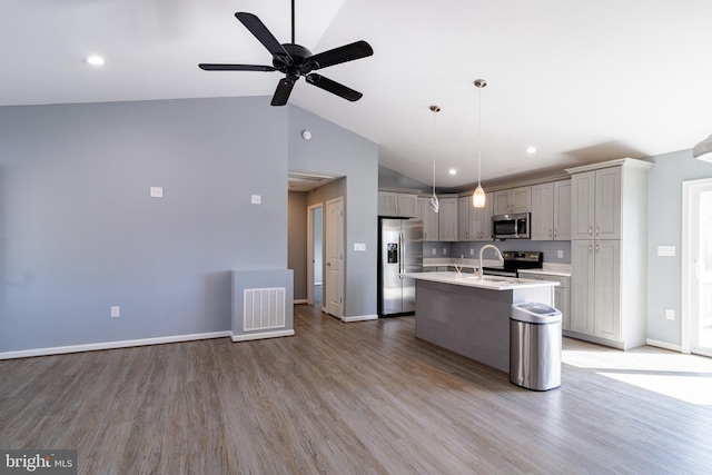 87 Tulip Poplar Dr, Linden, VA 22642 - kitchen featuring stainless steel appliances, lofted ceiling, light countertops, light wood-type flooring, and a center island with sink