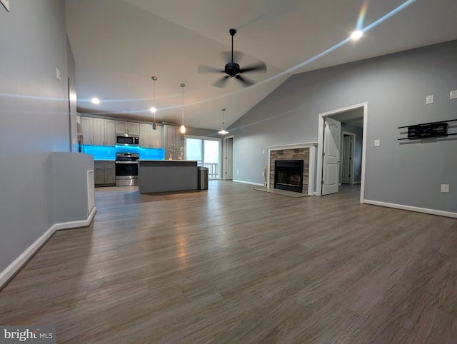 87 Tulip Poplar Dr, Linden, VA 22642 - unfurnished living room featuring a ceiling fan, lofted ceiling, dark wood finished floors, baseboards, and a fireplace