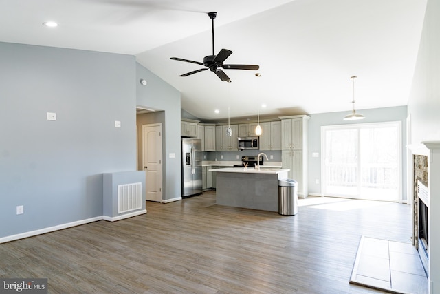 87 Tulip Poplar Dr, Linden, VA 22642 - kitchen with appliances with stainless steel finishes, ceiling fan, open floor plan, light countertops, and a tiled fireplace