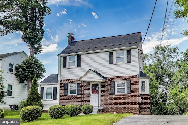 5016 56th Ave, Hyattsville, MD 20781 - view of front of house featuring a chimney, brick siding, roof with shingles, and entry steps