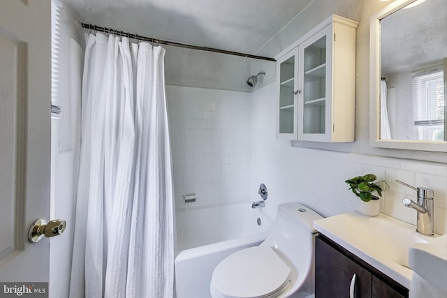 5016 56th Ave, Hyattsville, MD 20781 - bathroom with vanity, shower / tub combo, tile walls, and tasteful backsplash
