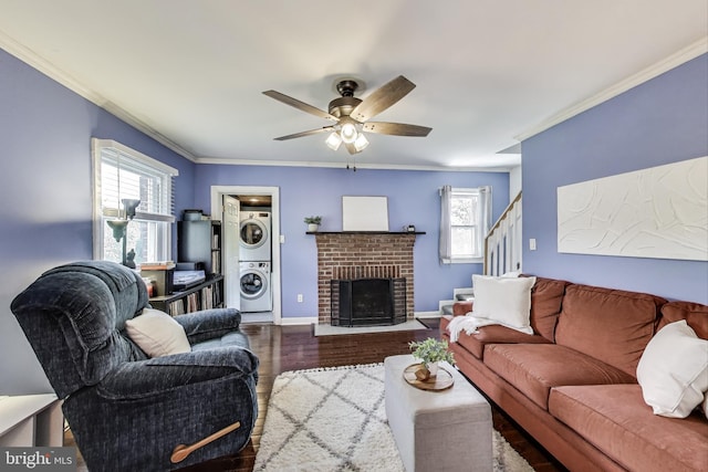 5016 56th Ave, Hyattsville, MD 20781 - living room featuring stacked washing machine and dryer, ornamental molding, wood finished floors, ceiling fan, and stairs