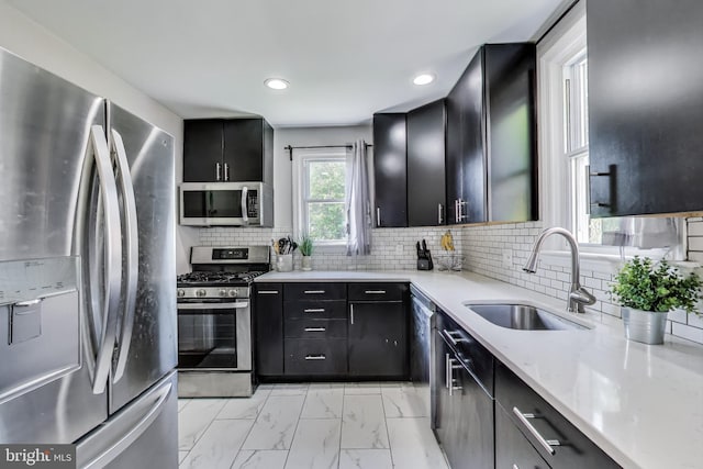 5016 56th Ave, Hyattsville, MD 20781 - kitchen featuring stainless steel appliances, dark cabinets, light marble finish flooring, recessed lighting, and decorative backsplash