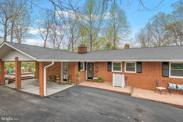1008 Harbour Dr, Stafford, VA 22554 - single story home featuring brick siding, a chimney, and roof with shingles