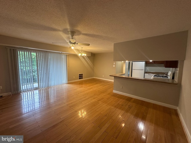 7980 Audubon Ave Unit C3, Alexandria, VA 22306 - unfurnished living room featuring baseboards, a ceiling fan, light wood-style flooring, and a textured ceiling