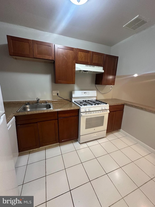 7980 Audubon Ave Unit C3, Alexandria, VA 22306 - kitchen with white gas range, a sink, under cabinet range hood, and light tile patterned floors