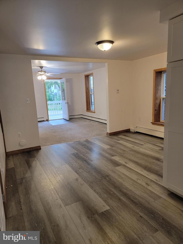 128 W Main St, New Bloomfield, PA 17068 - empty room featuring a baseboard heating unit, wood finished floors, and a ceiling fan