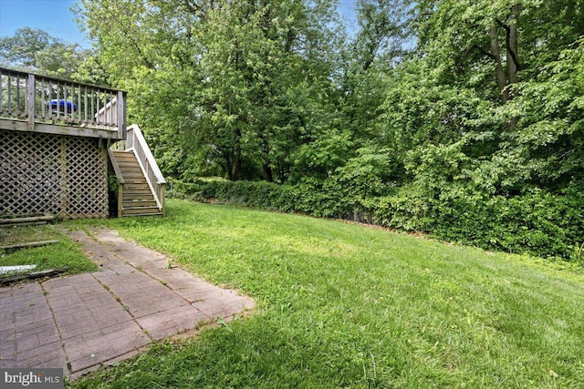 6548 10th St, Chesapeake Beach, MD 20732 - view of green lawn featuring stairs and a wooden deck