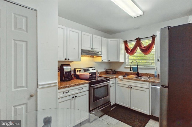 6548 10th St, Chesapeake Beach, MD 20732 - kitchen with stainless steel appliances, a sink, under cabinet range hood, and white cabinets