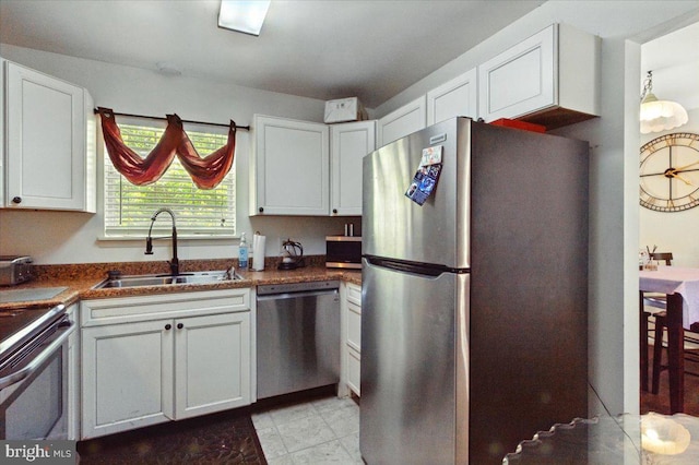 6548 10th St, Chesapeake Beach, MD 20732 - kitchen featuring stainless steel appliances, a sink, white cabinets, and dark countertops
