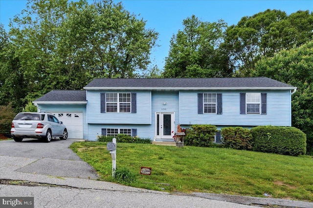 6548 10th St, Chesapeake Beach, MD 20732 - raised ranch featuring an attached garage, a front yard, and driveway