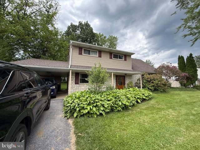 3809 Carriage House Dr, Camp Hill, PA 17011 - traditional-style home featuring a carport, a front yard, and driveway
