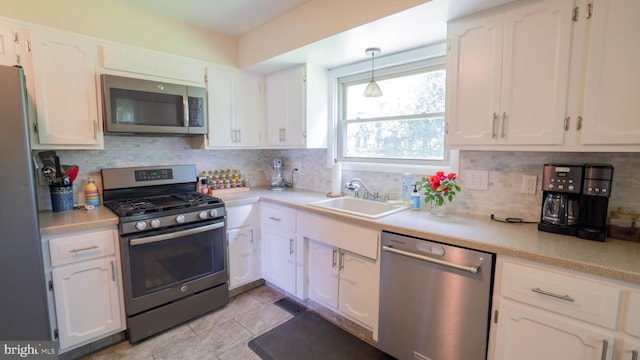 3809 Carriage House Dr, Camp Hill, PA 17011 - kitchen with appliances with stainless steel finishes, white cabinets, tasteful backsplash, and light countertops