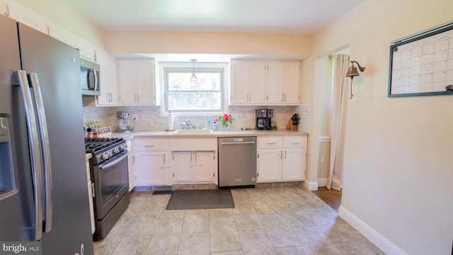 3809 Carriage House Dr, Camp Hill, PA 17011 - kitchen featuring appliances with stainless steel finishes, white cabinets, and decorative backsplash