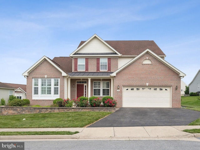 24 Tocati St, Thurmont, MD 21788 - traditional-style house featuring brick siding, asphalt driveway, a front lawn, a garage, and a standing seam roof