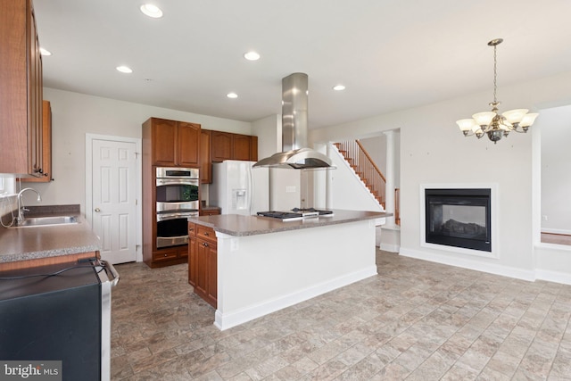 24 Tocati St, Thurmont, MD 21788 - kitchen featuring stainless steel appliances, island range hood, brown cabinetry, a chandelier, and a kitchen island