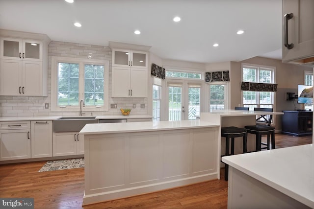 5438 Sherman Oaks Ct, Haymarket, VA 20169 - kitchen featuring decorative backsplash, light countertops, light wood-style flooring, and recessed lighting
