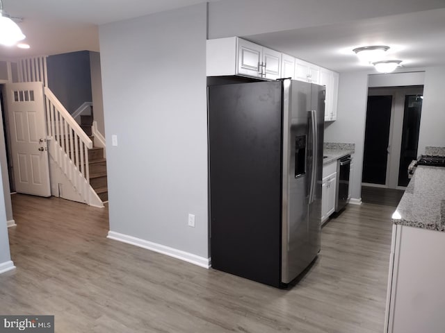 2573 Paxton St, Woodbridge, VA 22192 - kitchen featuring stainless steel appliances, white cabinets, light wood-type flooring, and baseboards