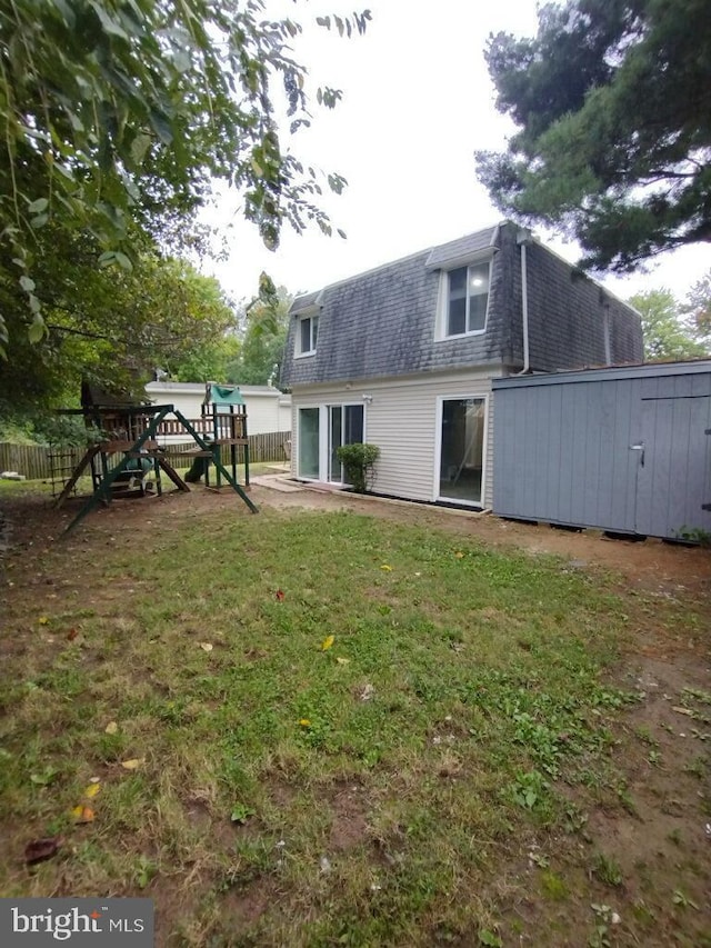 2573 Paxton St, Woodbridge, VA 22192 - back of house with a shingled roof, mansard roof, and a playground