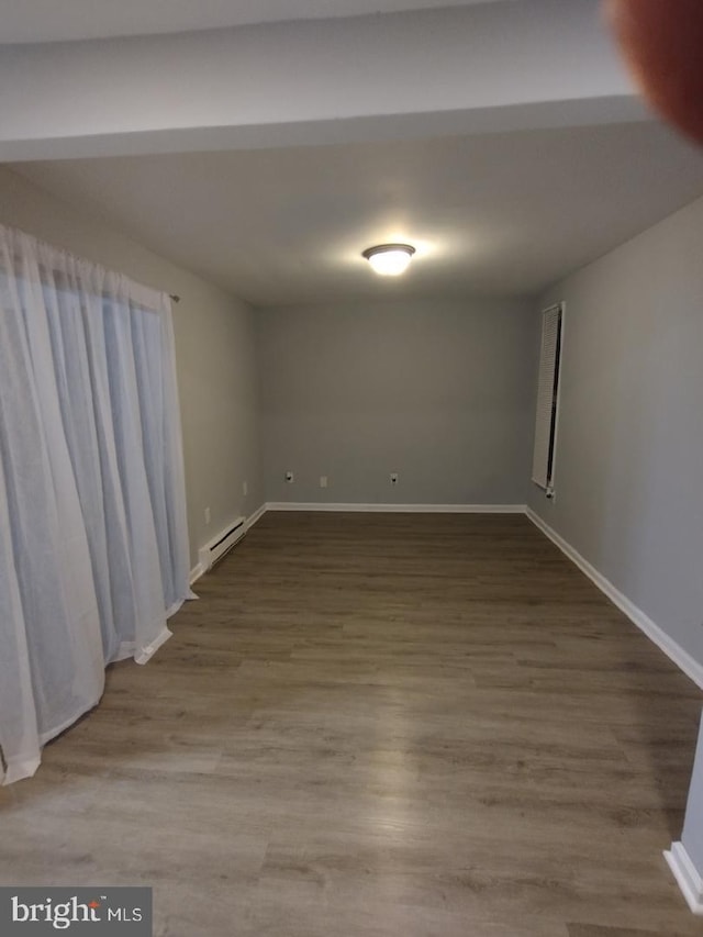 2573 Paxton St, Woodbridge, VA 22192 - empty room with baseboards, wood finished floors, and a baseboard radiator