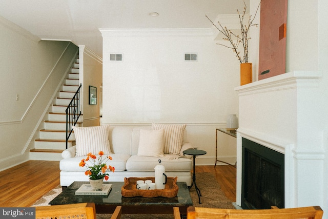 708 9th St SE, Washington, DC 20003 - living room featuring ornamental molding, wood finished floors, stairs, and a fireplace