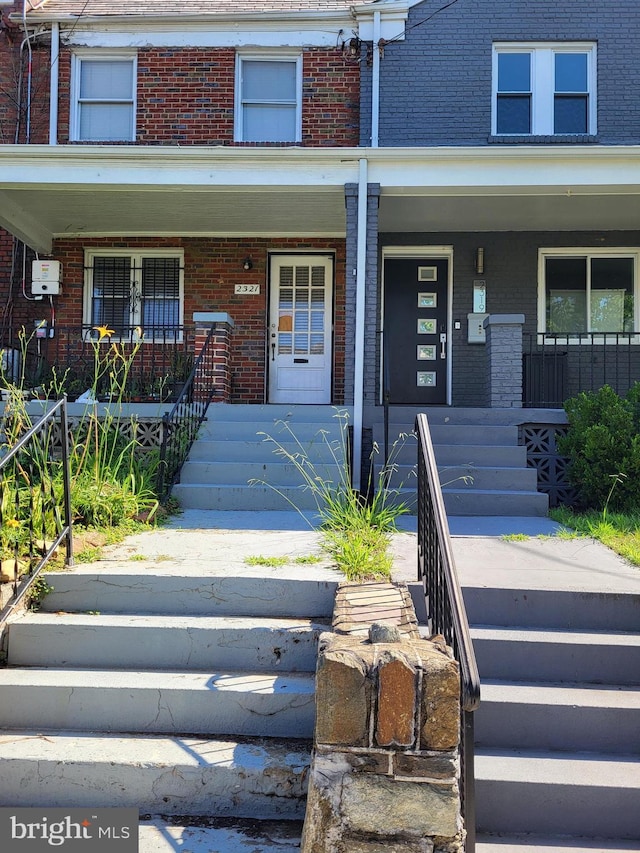 2321 13th Pl NE, Washington, DC 20018 - view of front of home with covered porch, brick siding, and stairway