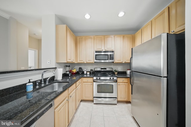 2465 Army Navy Dr Unit 1-303, Arlington, VA 22206 - kitchen with stainless steel appliances, light brown cabinetry, a sink, light tile patterned floors, and dark stone countertops