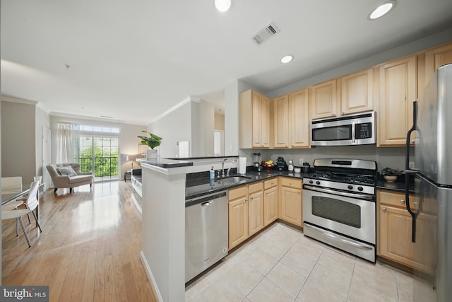 2465 Army Navy Dr Unit 1-303, Arlington, VA 22206 - kitchen featuring appliances with stainless steel finishes, light brown cabinetry, a sink, ornamental molding, and open floor plan