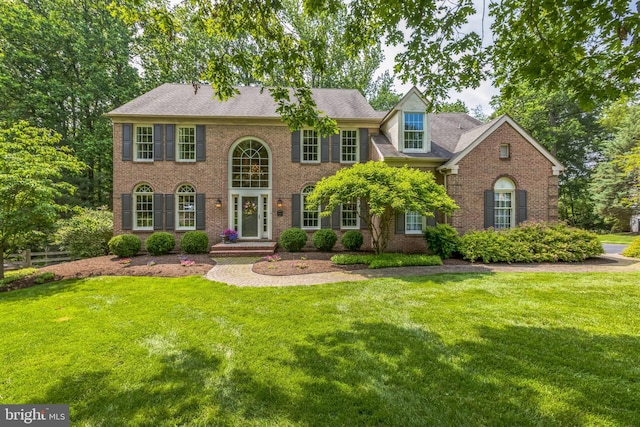 1337 Pennsridge Pl, Downingtown, PA 19335 - colonial home with brick siding, a front yard, and a shingled roof