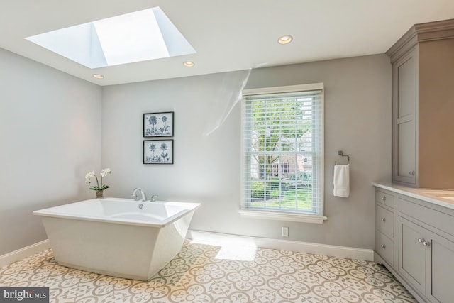 1337 Pennsridge Pl, Downingtown, PA 19335 - bathroom with a skylight, baseboards, a soaking tub, vanity, and recessed lighting