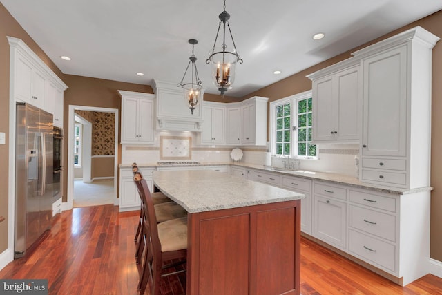 1337 Pennsridge Pl, Downingtown, PA 19335 - kitchen with appliances with stainless steel finishes, wood finished floors, white cabinets, and recessed lighting