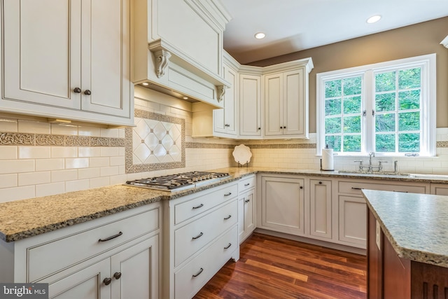 1337 Pennsridge Pl, Downingtown, PA 19335 - kitchen with stainless steel gas cooktop, a sink, dark wood-style floors, decorative backsplash, and light stone countertops