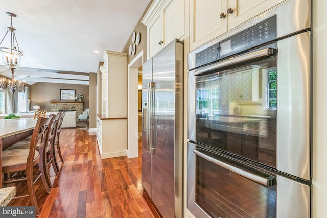 1337 Pennsridge Pl, Downingtown, PA 19335 - kitchen featuring appliances with stainless steel finishes, dark wood finished floors, open floor plan, a chandelier, and baseboards