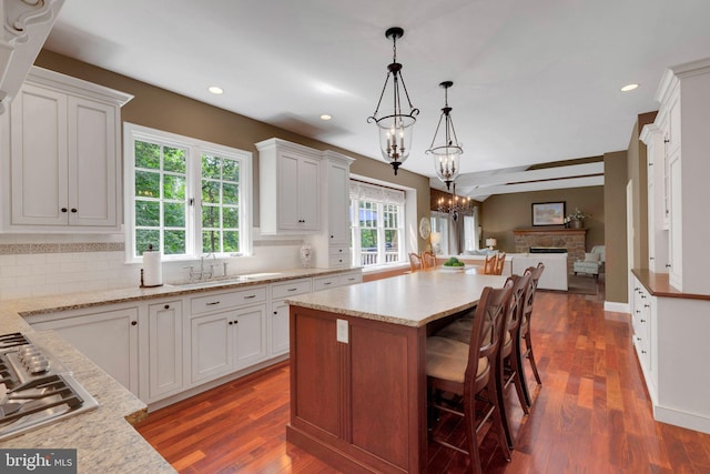 1337 Pennsridge Pl, Downingtown, PA 19335 - kitchen with open floor plan, stainless steel gas stovetop, a chandelier, a sink, and decorative backsplash