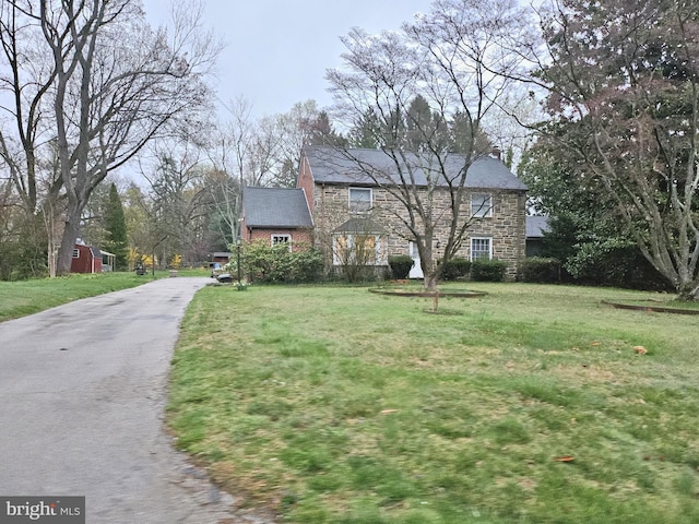 211 Mount Alverno Rd, Media, PA 19063 - view of front of house featuring stone siding, a front lawn, and driveway