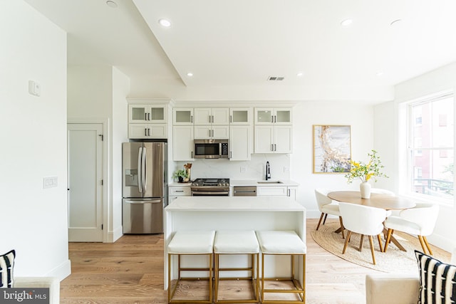 2517 Ontario Rd NW Unit Ph8, Washington, DC 20009 - kitchen with appliances with stainless steel finishes, a sink, light countertops, light wood-style floors, and recessed lighting