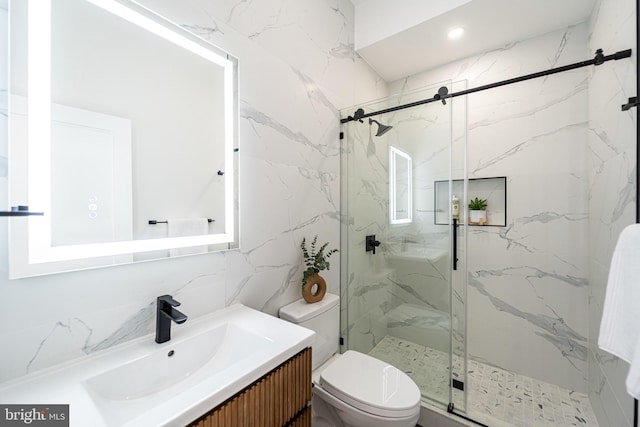2517 Ontario Rd NW Unit Ph8, Washington, DC 20009 - bathroom featuring toilet, vanity, a marble finish shower, and tile walls