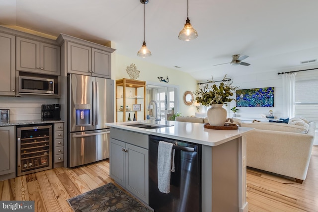 120 Read Ave, Dewey Beach, DE 19971 - kitchen featuring appliances with stainless steel finishes, wine cooler, gray cabinetry, a sink, and open floor plan