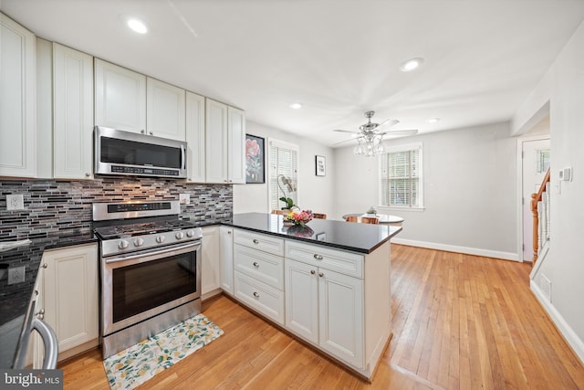 10004 Lorain Ave, Silver Spring, MD 20901 - kitchen featuring stainless steel appliances, a peninsula, dark countertops, tasteful backsplash, and recessed lighting