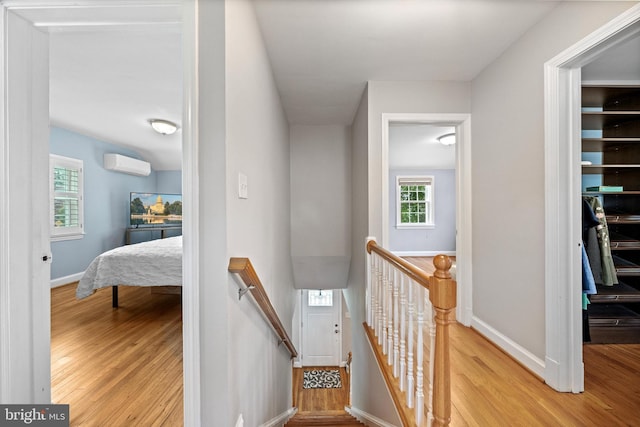 10004 Lorain Ave, Silver Spring, MD 20901 - staircase featuring an AC wall unit, wood finished floors, and baseboards